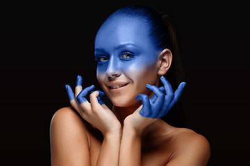 Image showing Portrait of a woman who is posing covered with blue paint