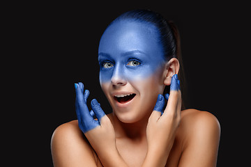 Image showing Portrait of a woman who is posing covered with blue paint