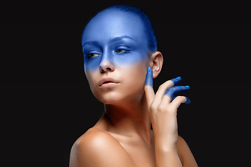 Image showing Portrait of a woman who is posing covered with blue paint