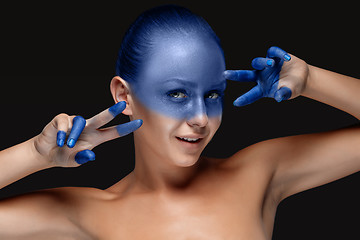 Image showing Portrait of a woman who is posing covered with blue paint