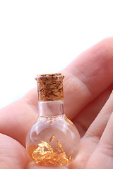 Image showing gold in small glass bottle 