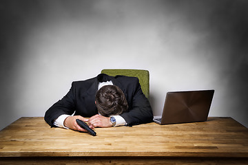 Image showing Overworked businessman with gun