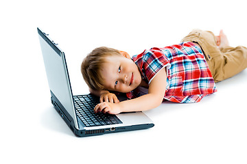 Image showing boy in a plaid shirt with a laptop on a white background.