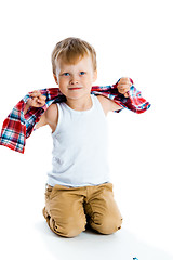 Image showing little boy in a plaid shirt over a white