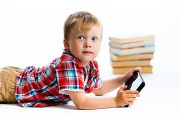 Image showing boy in a plaid shirt with a tablet computer against