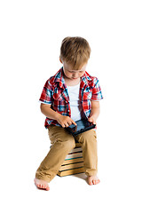 Image showing boy in a plaid shirt with a tablet computer