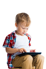 Image showing boy in a plaid shirt with a tablet computer