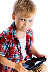 Image showing boy in a plaid shirt with a tablet computer