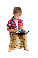 Image showing boy in a plaid shirt with a tablet computer