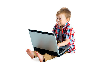 Image showing boy in a plaid shirt with a laptop on a white background.