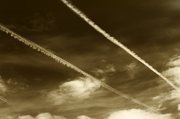 Image showing Sepia sky with contrails