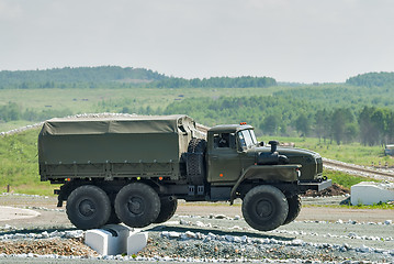 Image showing Army truck URAL-4320 jumps through obstacle