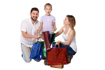 Image showing Happy family with shopping bags sitting at studio 