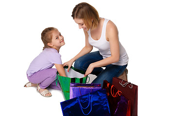 Image showing Happy a mother and daughter with shopping bags sitting at studio 