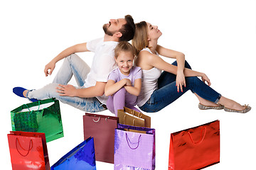 Image showing Happy family with shopping bags sitting at studio 