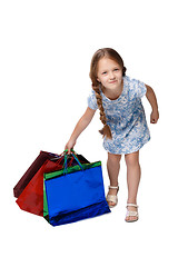 Image showing Happy girl with shopping bags standing at studio 