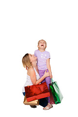 Image showing Happy a mother and daughter with shopping bags standing at studio 
