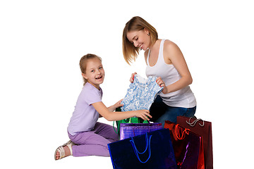 Image showing Happy a mother and daughter with shopping bags sitting at studio 