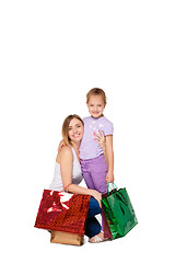 Image showing Happy a mother and daughter with shopping bags standing at studio 