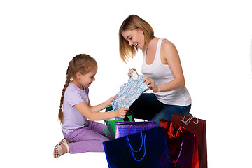 Image showing Happy a mother and daughter with shopping bags sitting at studio 