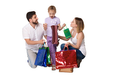 Image showing Happy family with shopping bags sitting at studio 