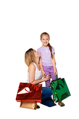 Image showing Happy a mother and daughter with shopping bags standing at studio 