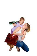 Image showing Happy a mother and daughter with shopping bags standing at studio 