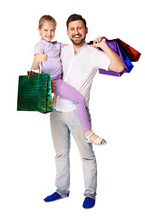 Image showing Happy father and daughter with shopping bags standing at studio 