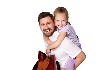 Image showing Happy father and daughter with shopping bags standing at studio 