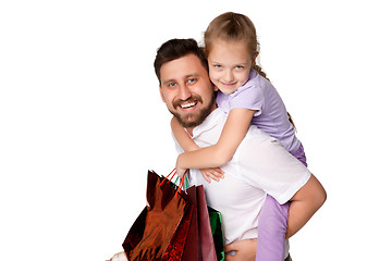 Image showing Happy father and daughter with shopping bags standing at studio 