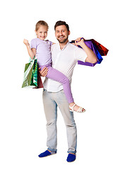Image showing Happy father and daughter with shopping bags standing at studio 