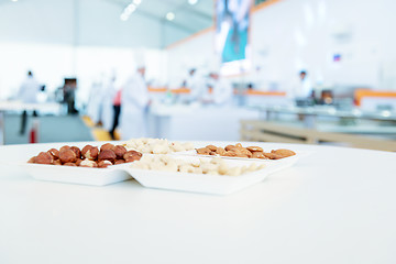 Image showing nuts mix in square paper plates