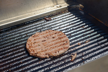 Image showing succulent grilled steak on hot grill