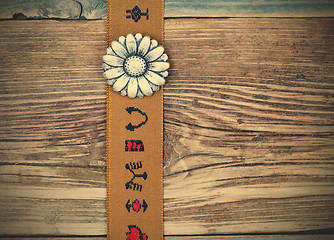 Image showing vintage tape with embroidered ornaments and old flower button