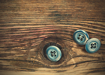 Image showing vintage buttons on the aged textured boards