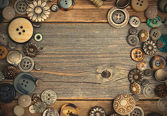 Image showing placer of vintage buttons with copy space on textured old boards