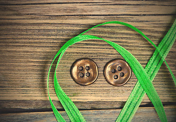 Image showing still life with old green tape and two vintage buttons