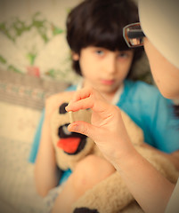 Image showing doctor with pill and boy