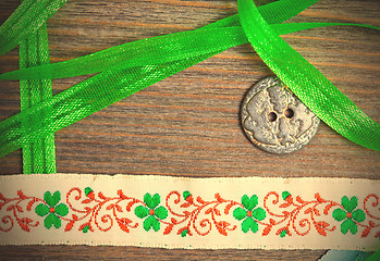 Image showing vintage embroidered band and tape with old classic button