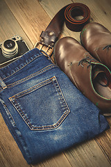 Image showing brown boots, blue jeans, leather belt and rangefinder camera