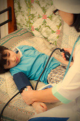 Image showing Doctor pediatrician measure blood pressure
