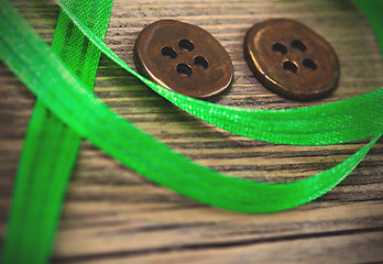 Image showing still life with old green tape and two vintage buttons