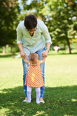 Image showing mother and baby in park making first steps