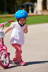 Image showing Boy and girl in park learning to ride a bike