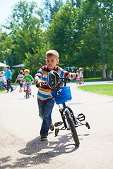 Image showing happy boy learning to ride his first bike