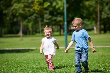 Image showing Boy and girl have fun and running in park