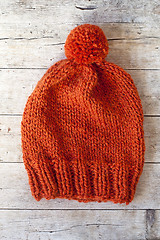 Image showing wool orange pompom hat