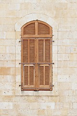 Image showing Closed window of the old building covered by wooden blinds