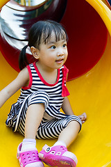 Image showing Asian kid sliding on Playground