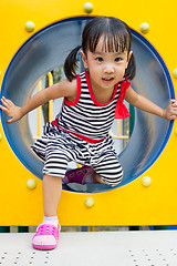 Image showing Asian Kid Crawling on Playground Tube